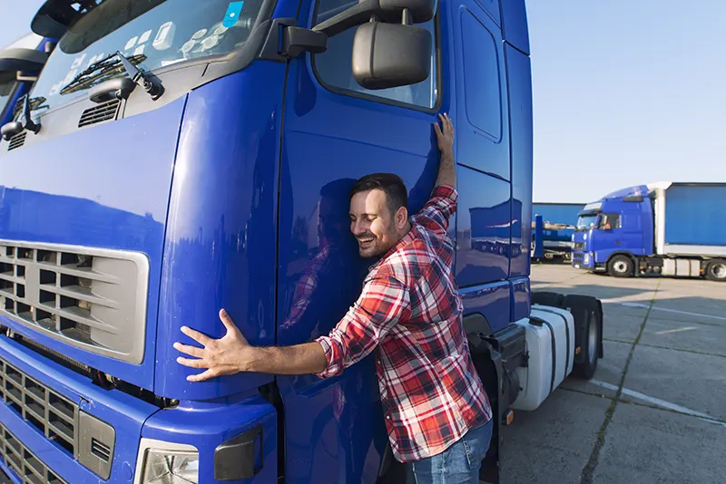 man hugging semi truck.